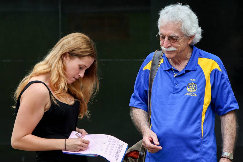 Wollongong Rotary president Leigh Robinson with Bulli resident Lauren Bell in Crown Street Mall, signing a petition to save the Albion Park helicopter service. Picture: ADAM McLEAN