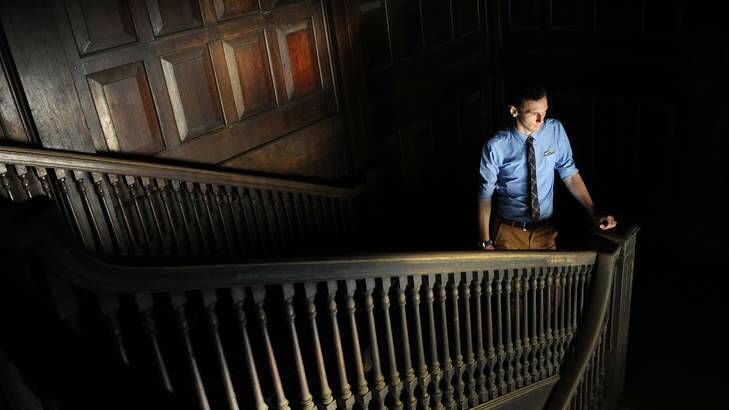 Faded glory ... Heritage consultant Rupert Mann on the teak staircase of the derelict colonial era Pegu club. Photo: Steve Tickner