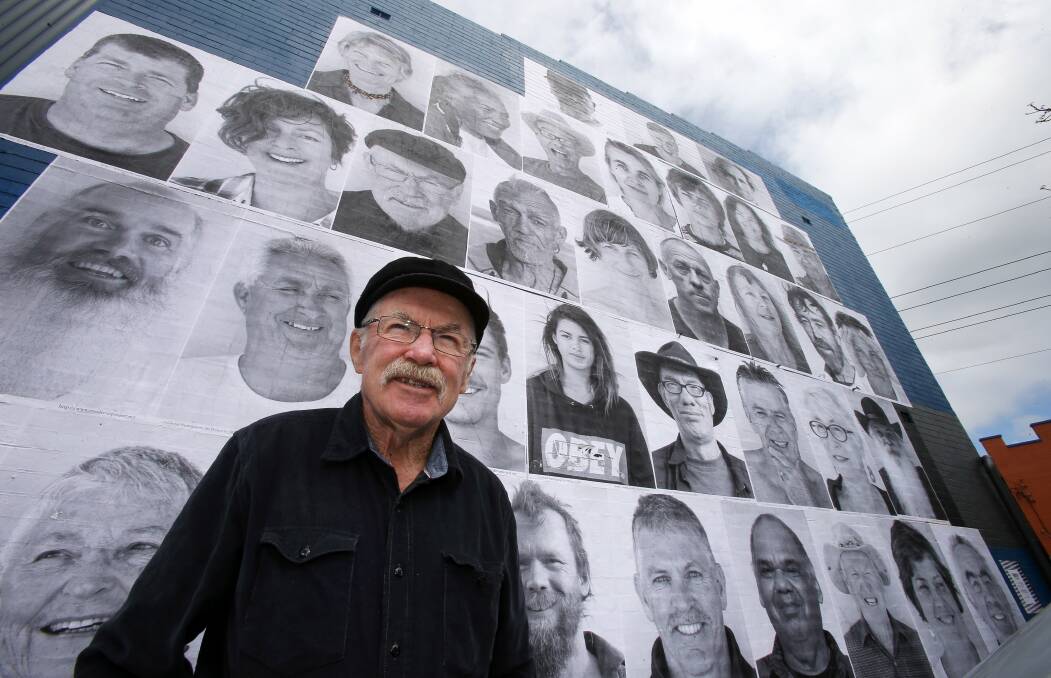 Gary Elliott in front of the wall of images adorning Thirroul. Picture: KIRK GILMOUR