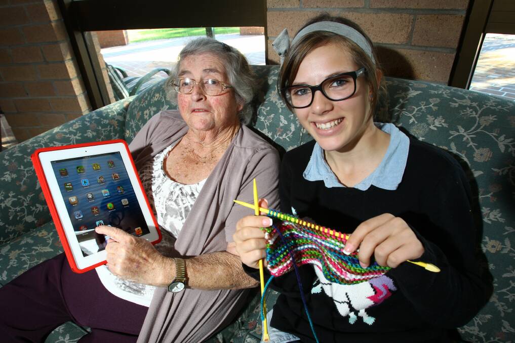 Colleen Marks, 73, has been teaching Madison Classen, 15, how to knit in return for iPad tips. Picture: KEN ROBERTSON