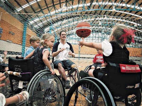 Brett Stibners, pictured playing basketball with the Skills for Life Children, has been honoured by Shellharbour City. Picture: SYLVIA LIBER