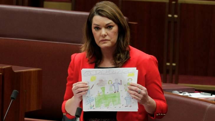 Pictures of despair … Greens senator Sarah Hanson-Young with drawings done by some of the 38 children held with their families at Papua New Guinea's Manus Island processing centre.
