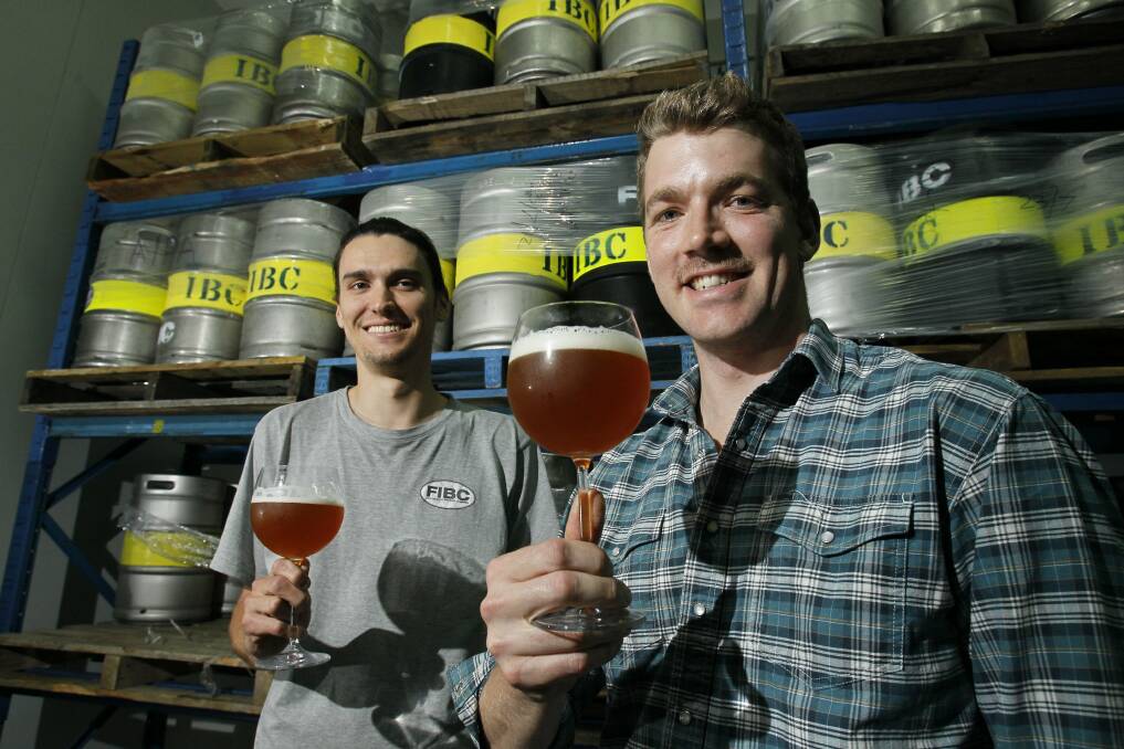 Shaun Blissett and Ashur Hall of the Illawarra Brewing Company raise a perfectly poured glass. Picture: DAVE TEASE