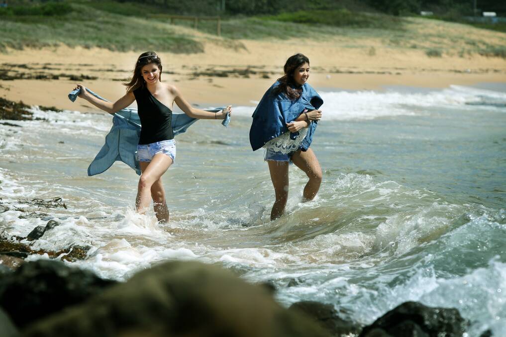Vivien Wickham and Alana Benn enjoy the brief respite from the wet weather at Werri Beach, Gerringong yesterday.Picture: SYLVIA LIBER