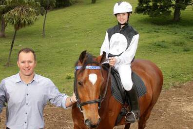 Horse trainer Peter Lord and daughter Molly on her horse Billy at their Thirroul home.