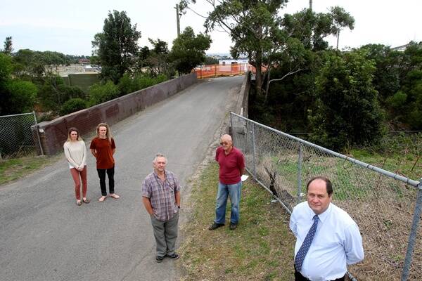 Councillor Greg Petty (right) with Bulli residents Jasmine Pescud (left), Jarred Pescud, their father Don and neighbour Dave Frith, who oppose the use of the Sturdee Ave bridge as a temporary southern access to Stockland's McCauley's Beach development.Picture: KIRK GILMOUR