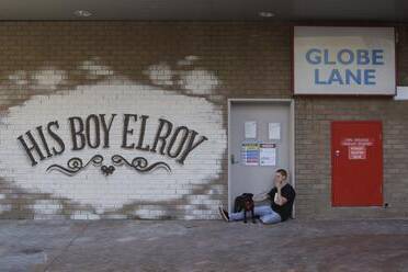 Chris Norris and Ruby sit in the doorway of what will become His Boy Elroy in the changing face of Globe Lane. Picture:  ANDY ZAKELI