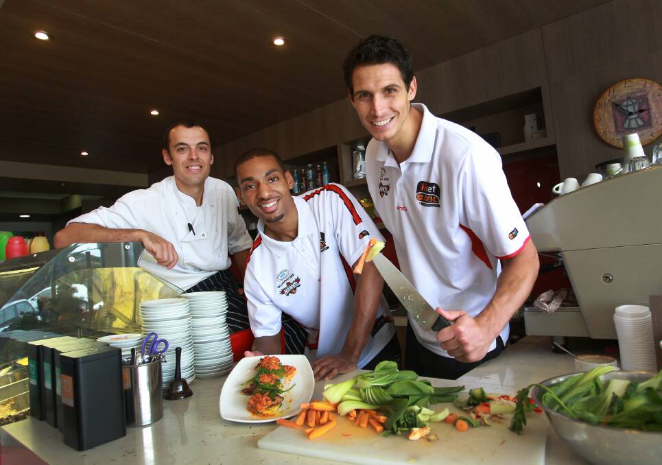 Chef Aaron Anderson, left, with Hawks pair Lance Hurdle and Oscar Forman. Picture: ORLANDO CHIODO