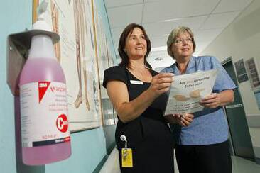 Manager Joanna Harris with registered nurse Karen Nakken with one of the alcohol-based hand rub pumps in Wollongong Hospital. Picture: DAVE TEASE