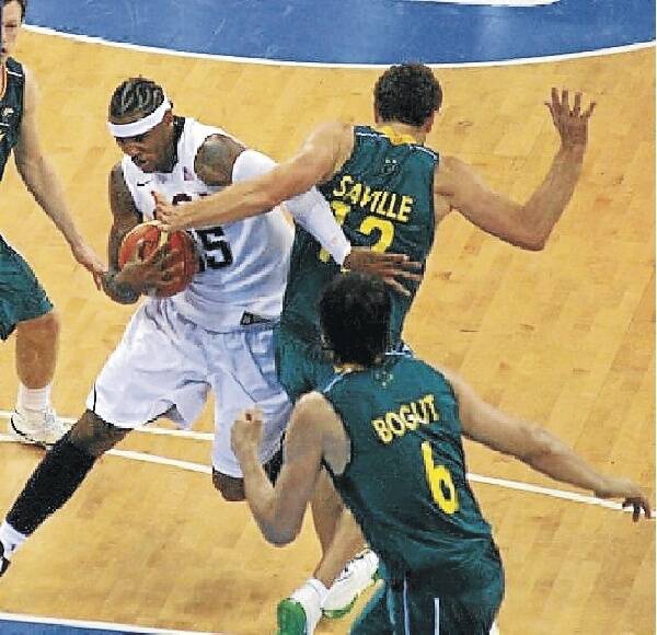 Mello move: Carmello Anthony uses an illegal move to drive past Glen Saville during their Olympic encounter.