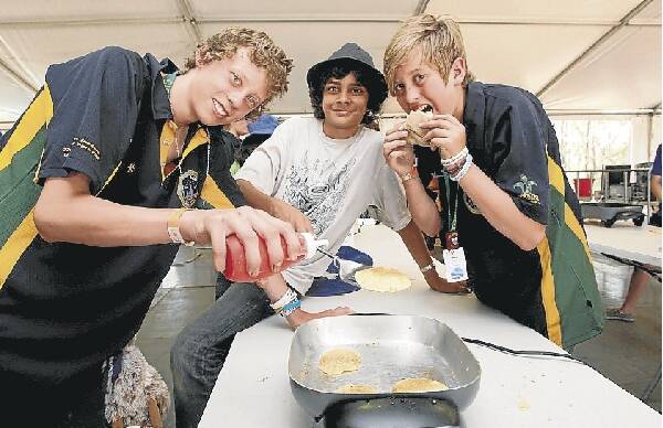 Brandon Orlov, Michael Apswoude and Ben Auhl get busy making pancakes. Pictures: SYLVIA LIBER and MELANIE RUSSELL