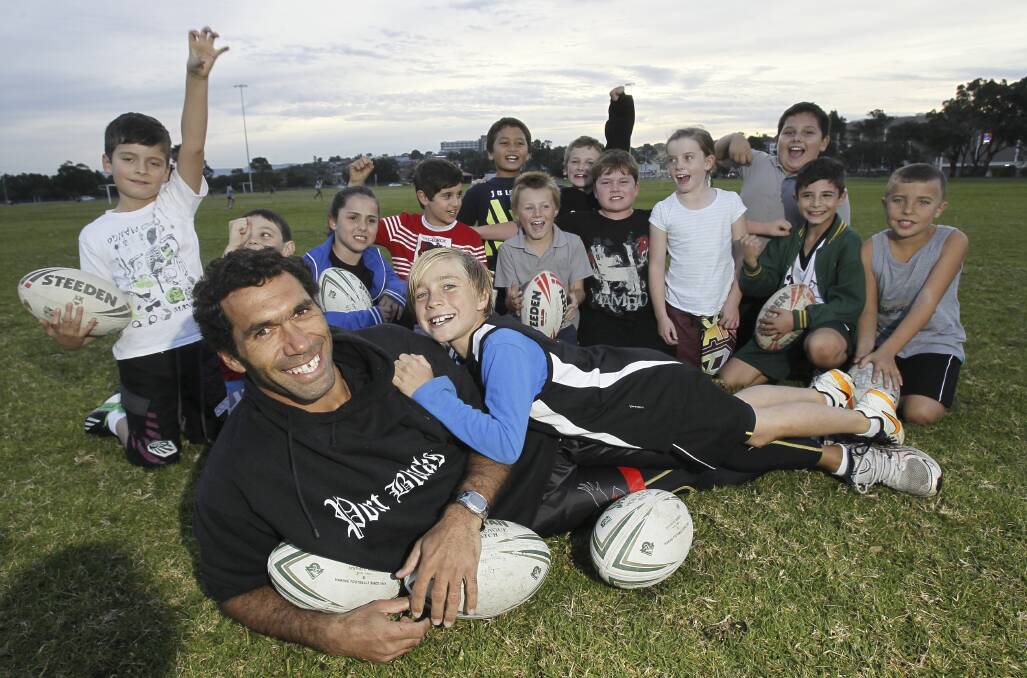 Port Kembla coach Mark Simon with his son Taj, and the under-9 team he coaches. Picture: DAVE TEASE