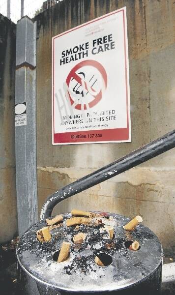Butts piled up beneath a no-smoking sign at Wollongong Hospital.
