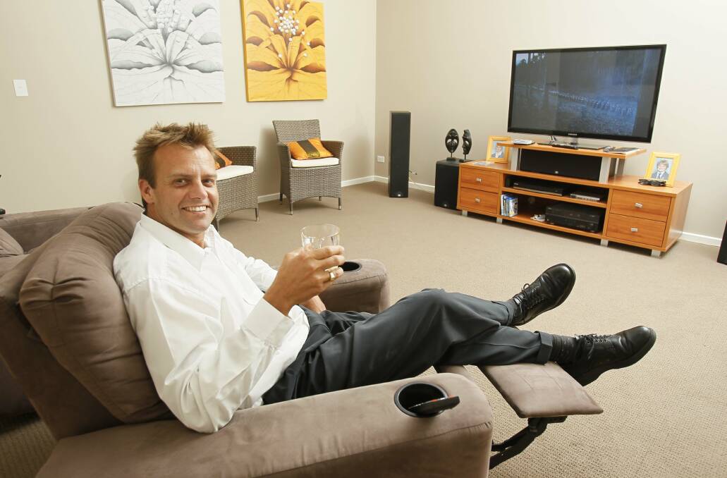 David Laing settles in for a movie with a glass of scotch in his home theatre.  Pictures: DAVID TEASE