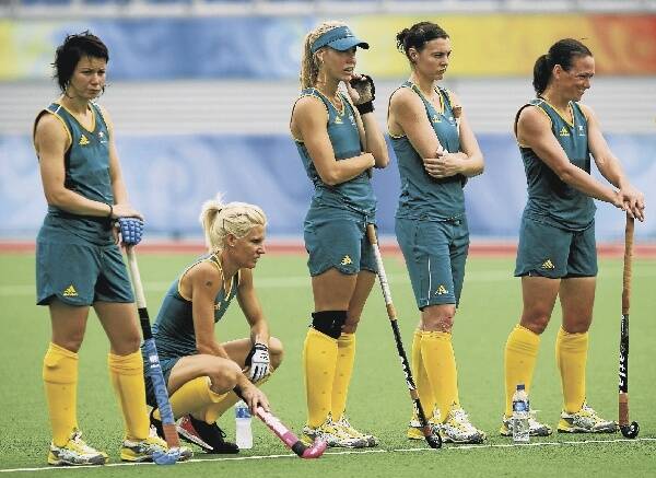 Australian women's hockey team members, including Casey Eastham (third from left), tune into their coach at a practice session yesterday in Beijing. The Australians are strongly fancied for an Olympic Games medal.Picture: GETTY IMAGES
