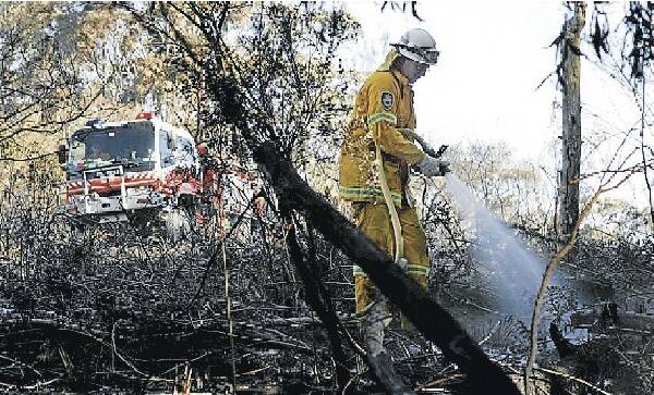 A volunteer firefighter battles the blaze that broke out at Mt Kembla yesterday. Picture: ANDY ZAKELI