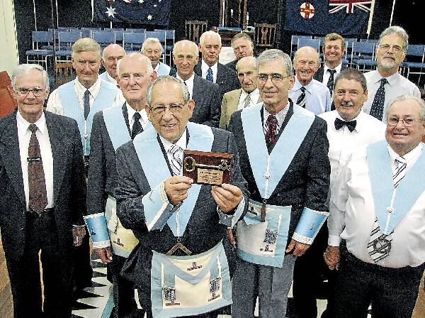 Bruce Radburn and fellow Freemasons with a key presented to the Berry Masons, which symbolises the opening of their lodge's doors to the community.