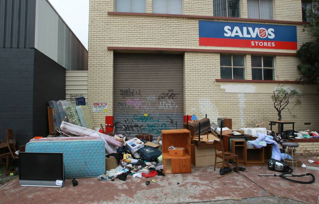 Discarded furniture and rubbish litter the front of the Salvation Army store.Picture: ORLANDO CHIODO