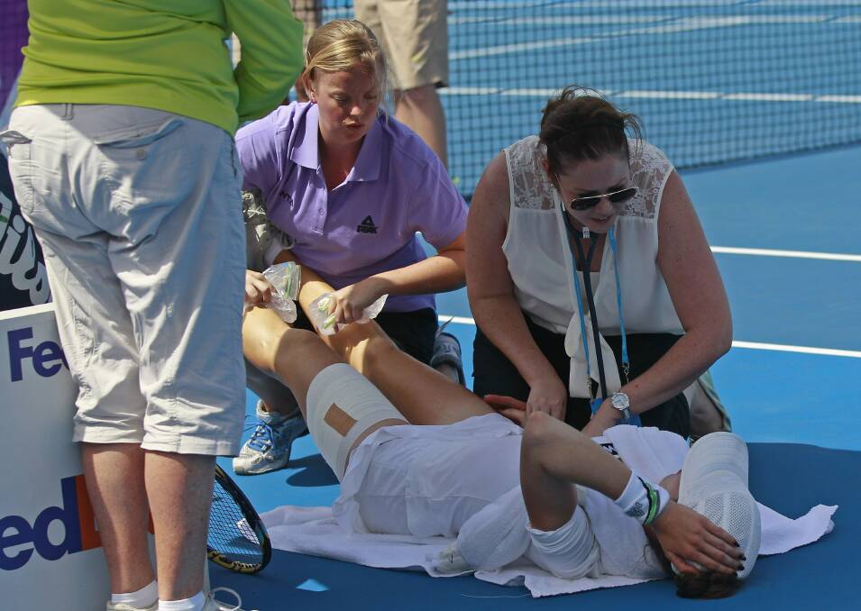 Galina Voskoboeva receives treatment after being affected by high temperatures. Pictures: GETTY IMAGES/REUTERS
