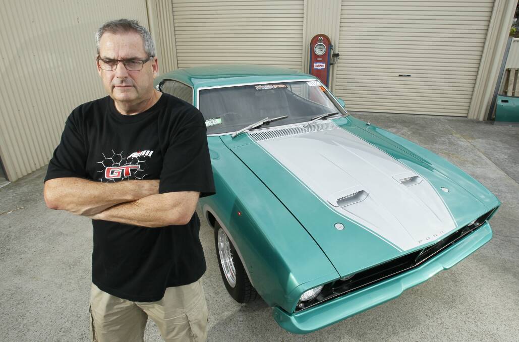 Howard Astill, 55, of Kanahooka with the 1976 Ford XB GT Coupe he lovingly restored.