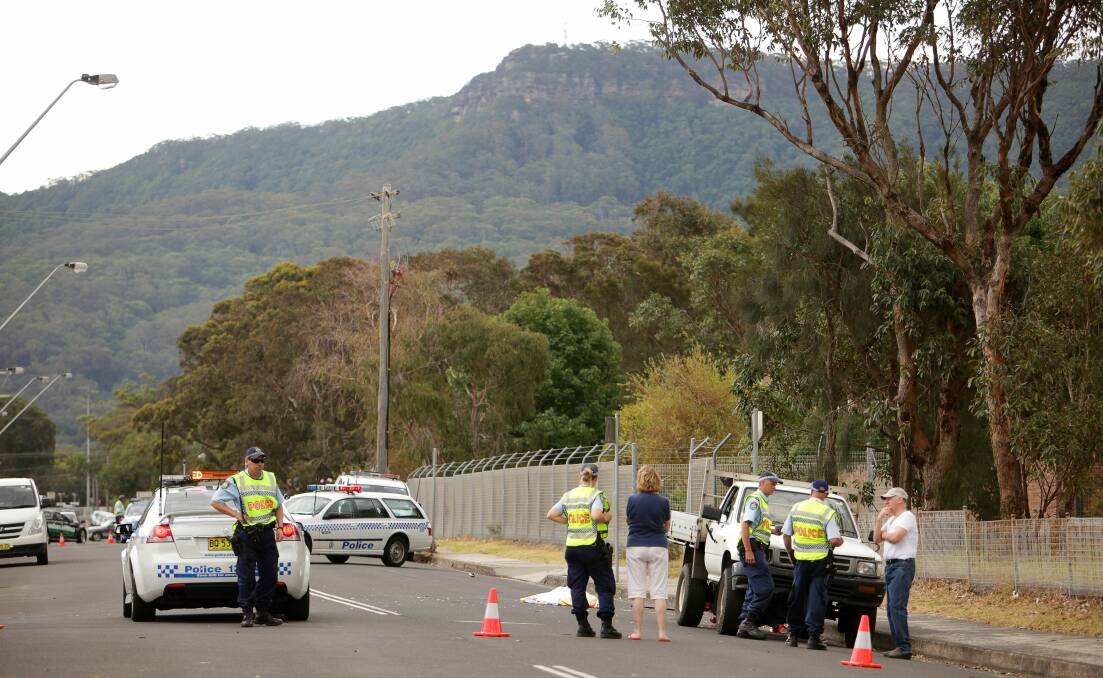 Police attend the scene of the fatal accident involving a ute and a pedestrian in East Corrimal yesterday. Picture: KIRK GILMOUR