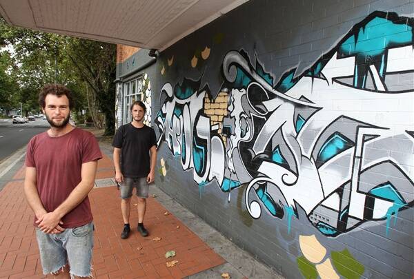 Balunn Jones and Adam Smith with the Yours and Owls gallery and bar’s artwork yesterday. Picture: KIRK GILMOUR
