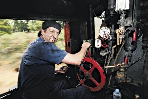 Co-driver John Mackie tends to the locomotive's every need.  Picture: KEN ROBERTSON