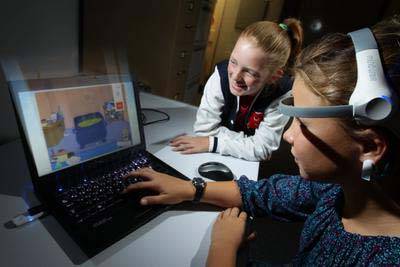 Eleven-year-olds Emma Johnstone (left), daughter of researcher Professor Stuart Johnstone, and Naomi Poscoliero learn how to play the game Focus Pocus, which has been designed to improve children’s memory, impulse control and focus.  Picture: KEN ROBERTSON