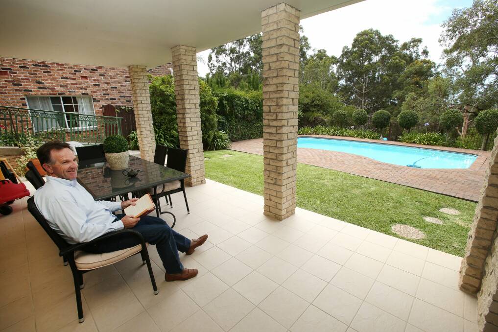 John Dorahy recuperates from hip surgery beside his pool at Figtree.