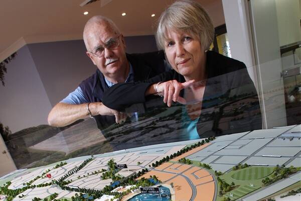 Shell Cove residents Ern and Cheryl Senior examine a model of the Shell Cove marina project at Australand's sales office in the suburb. Picture: KEN ROBERTSON
