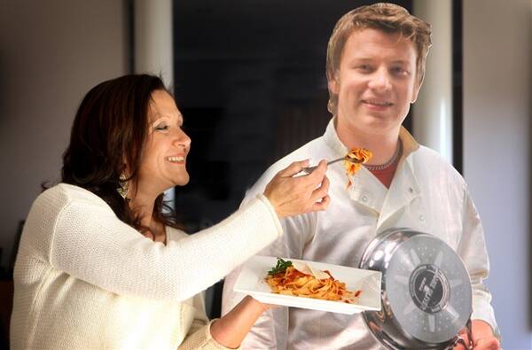 Home cook Gina Ottaway with her cardboard cut-out of Jamie Oliver, the man whom she says has it all.Picture: SYLVIA LIBER
