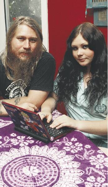 Warren Wheeler and daughter Milli, 15, are frustrated by restrictions on using school laptops provided under the Federal Government program. Picture: GREG TOTMAN