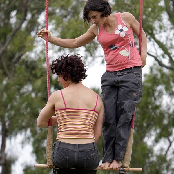 Parents upset: The two aerial trapeze artists from Melbourne who performed above the crowd before taking their shirts off. Inset: The performers prepare for their show at Viva la Gong in MacCabe Park. Inset picture: ANDY ZAKELI