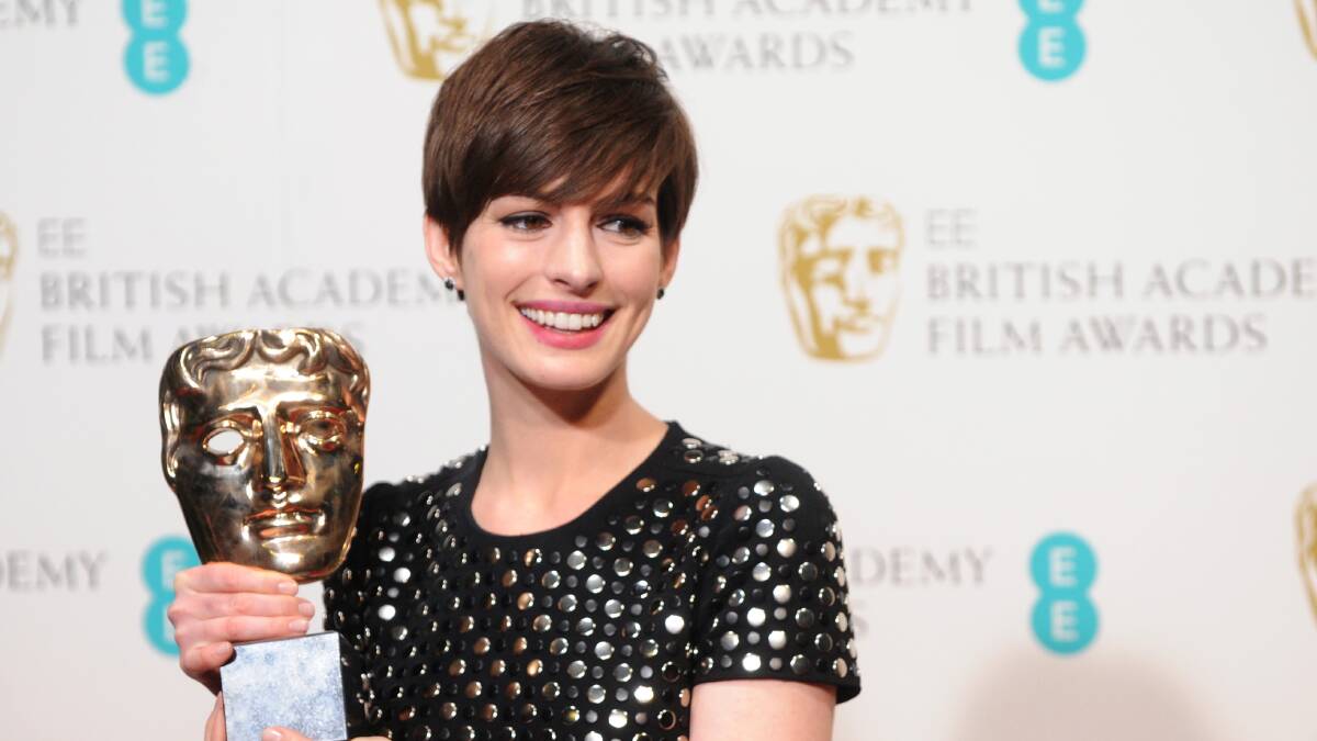 Anne Hathaway wins at the BAFTA awards. Photos: GETTY