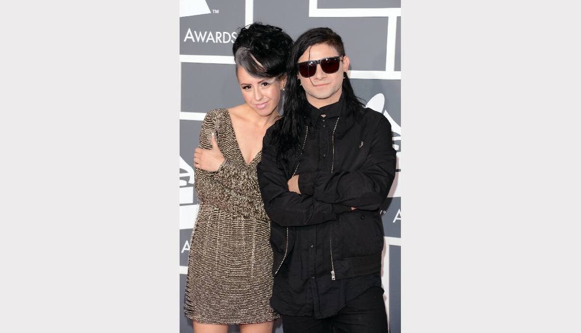 DJ/producer Skrillex (R) and recording artist Sirah arrive at the 55th Annual GRAMMY Awards.