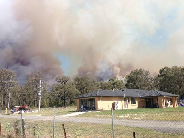 A Yanderra resident captured this picture of smoke hanging over a home.