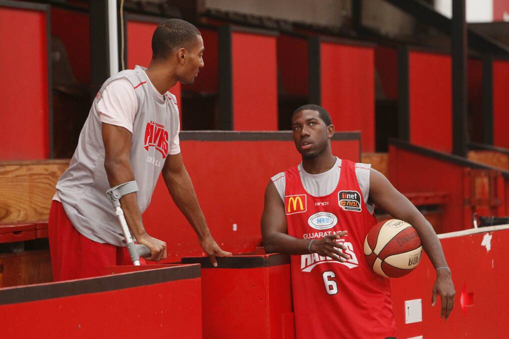 New Hawks import Malcolm Grant (right) chats with injured teammate Lance Hurdle.