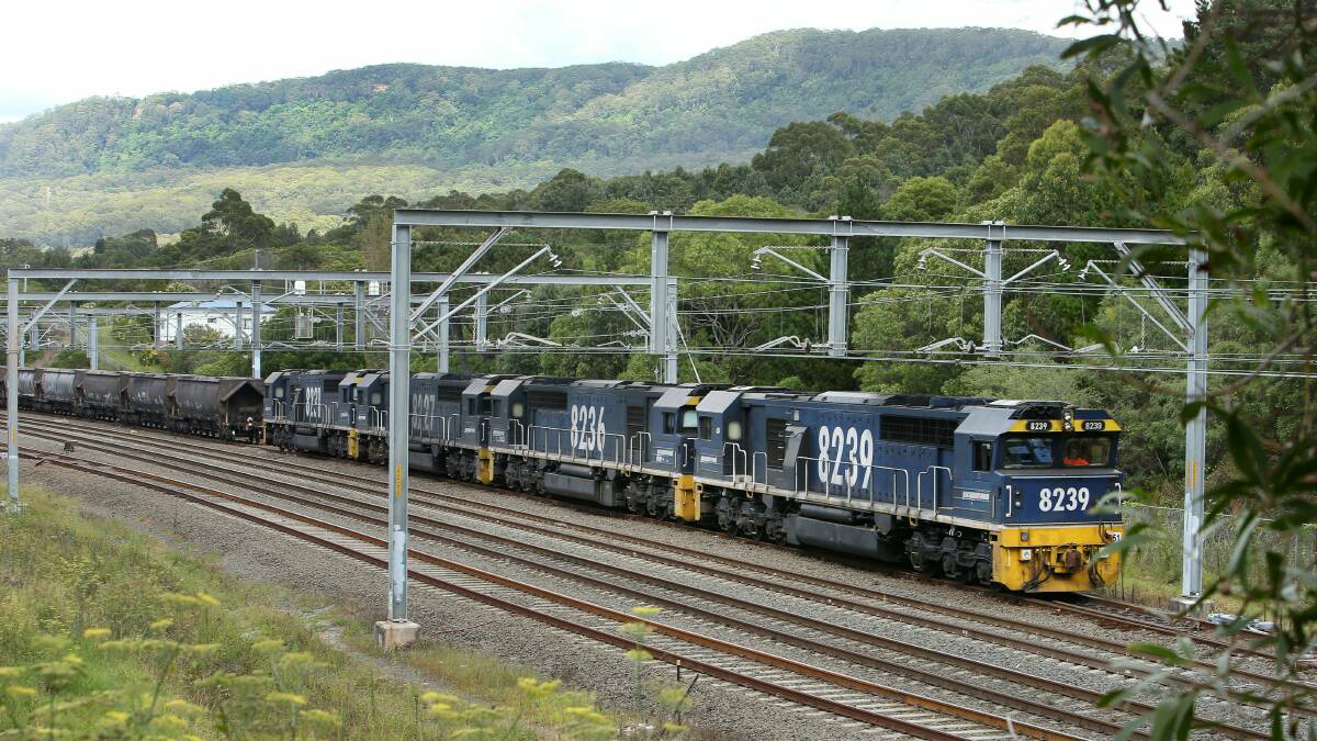A Pacific National diesel locomotive hauling coal wagons sits in a rail siding at Austinmer. Photo: KIRK GILMOUR