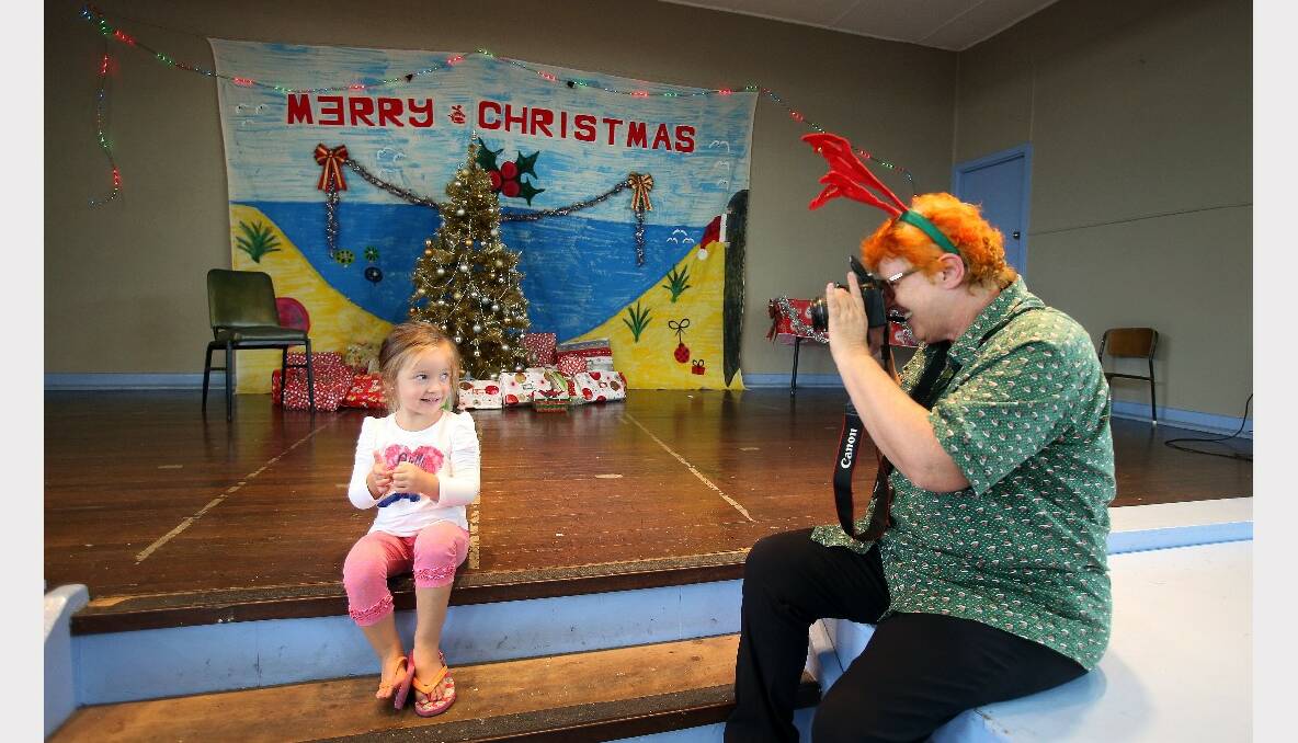 Natalija, three, has her photo taken by volunteer Phoenix Van Dyke at the Warrawong Community Centre Christmas lunch. PICTURE: KIRK GILMOUR