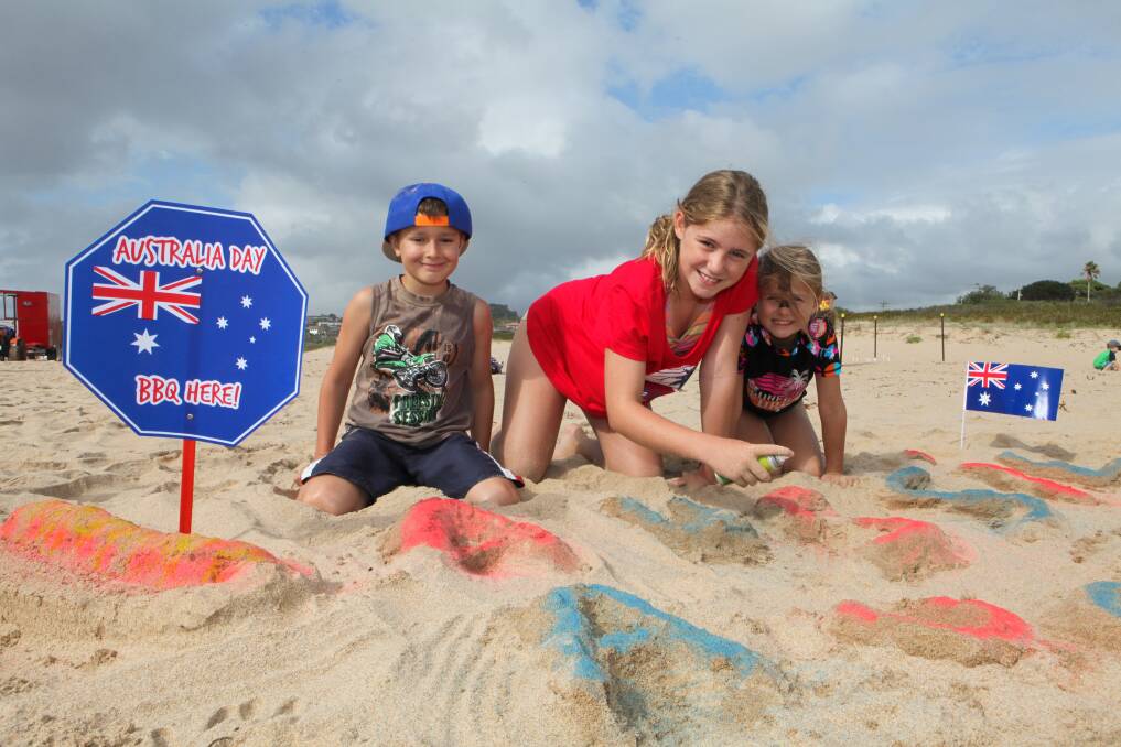 Zac Dudek, Shaylee Crowe and Alyssa Luhr get creative on the beach to celebrate Australia Day. Pictures: Dylan Robinson