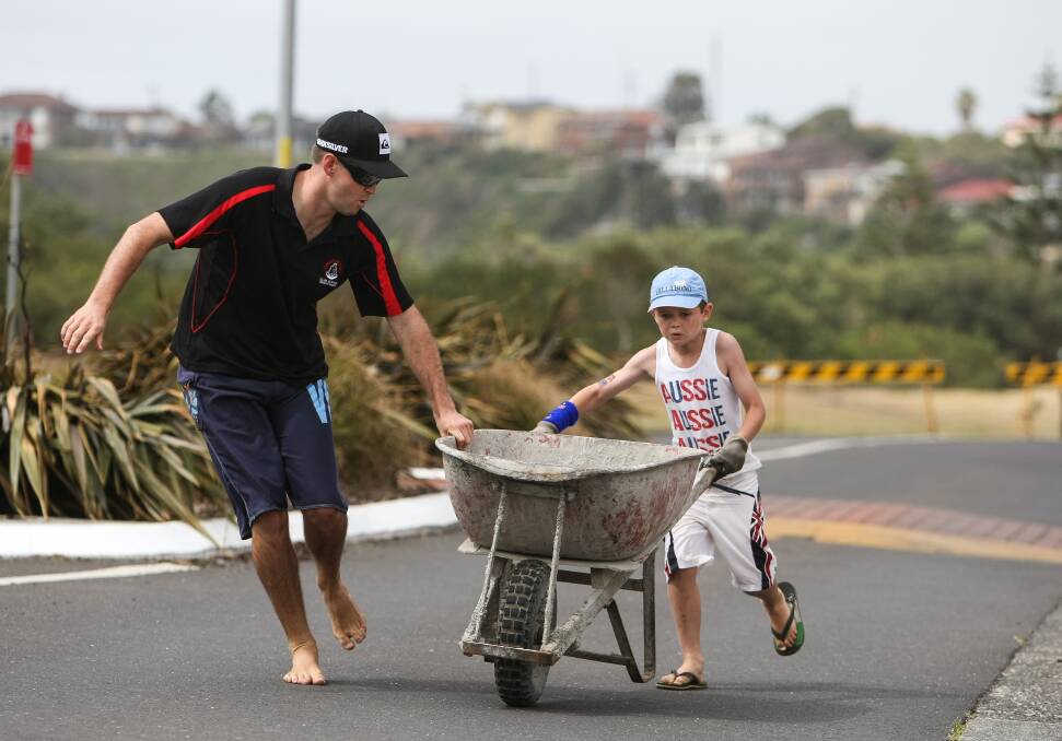 Kiama Downs' Blake Hornsby helps out Callum Young in the Kiama Australia Day brickies race.  Pictures: Dylan Robinson