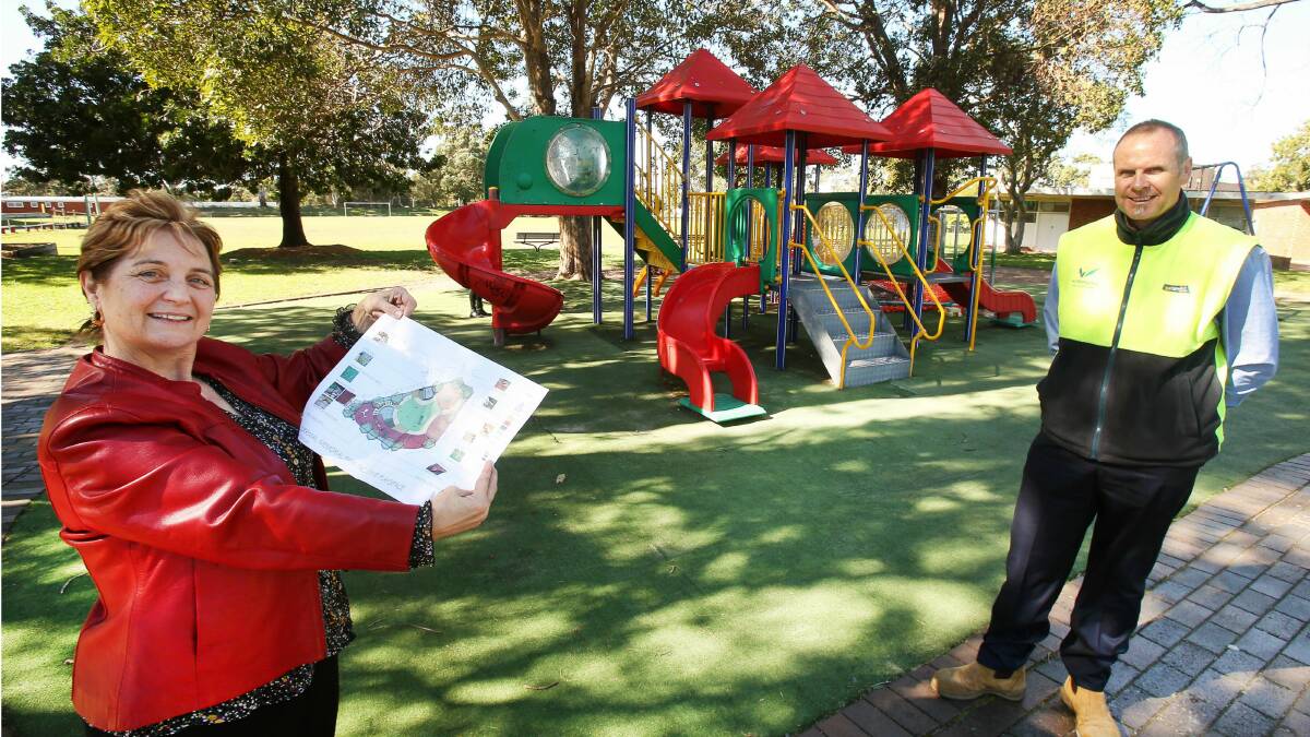 Wollongong City Council staff Jenny Thompson and Jeff Wearing with plans for the new inclusive playground at Memorial Park in Corrimal. Picture: KIRK GILMOUR