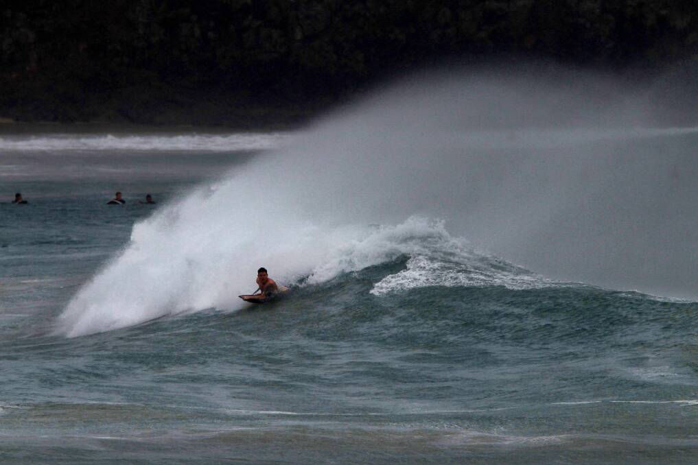 Surfers and body boarders take on big waves at The Farm. Pictures: SYLVIA LIBER