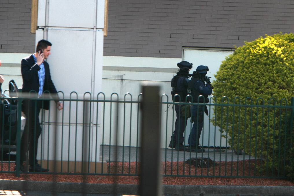 Armed tactical police at a siege in Warrawong. Picture: SYLVIA LIBER
