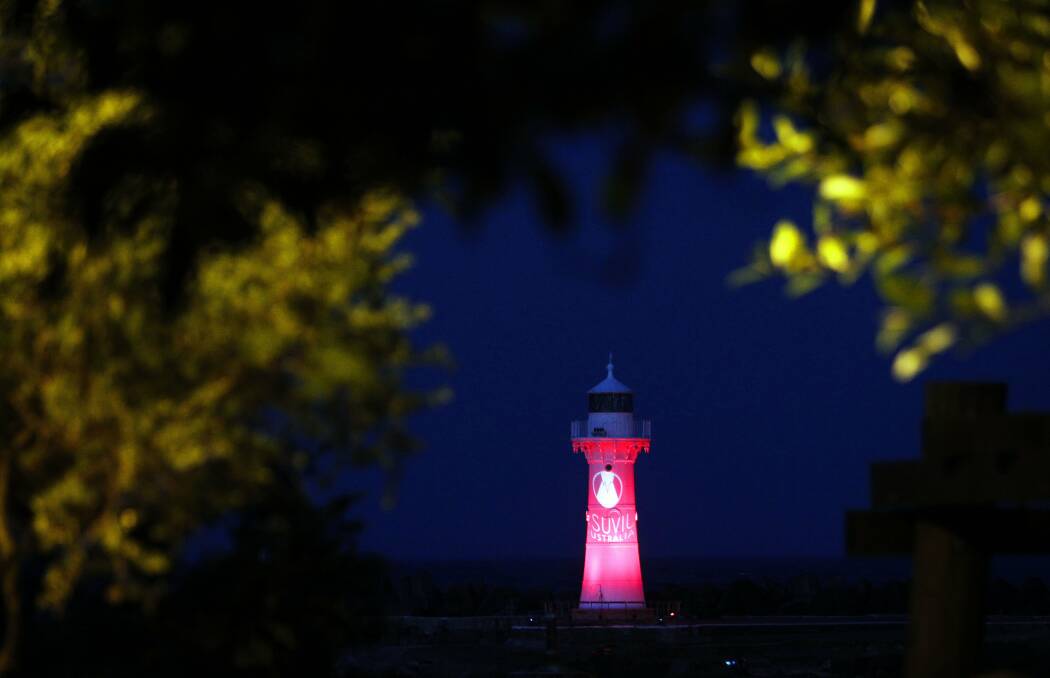 An image is projected on to the Little Lighthouse during a pre-fireworks light show at Belmore Basin.
