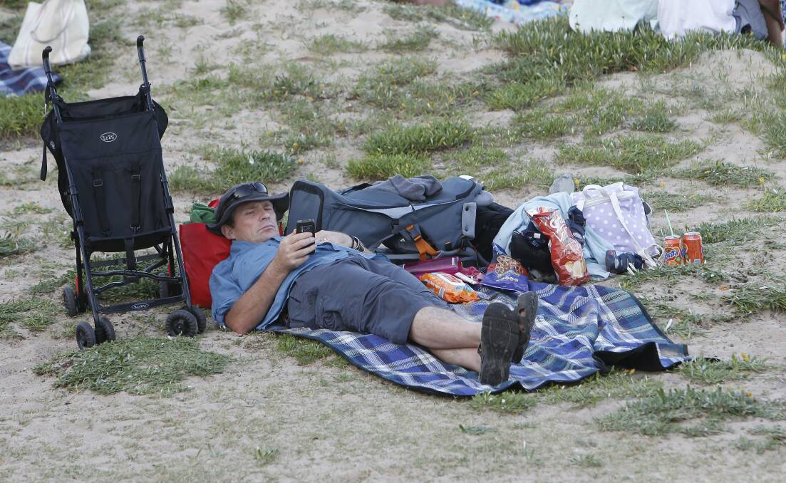 The calm before the storm: A man takes some time out before the fireworks begin at Belmore Basin.