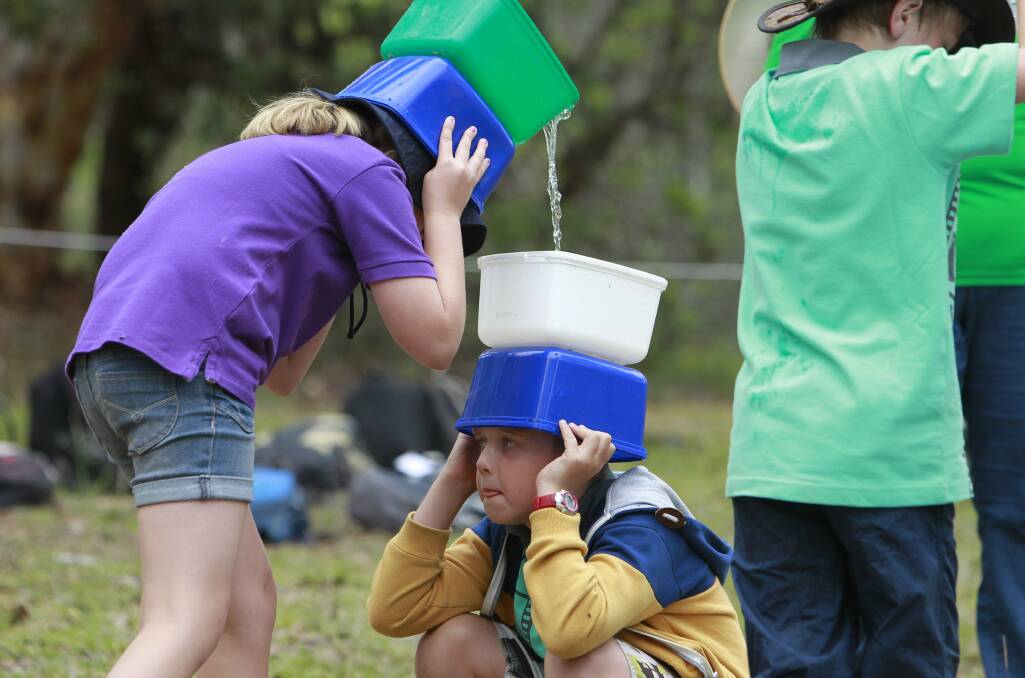 Bennett Rogers, of 1st Balgownie, looks nervous as he receives a load of water from his team-mate. Picture: ANDY ZAKELI