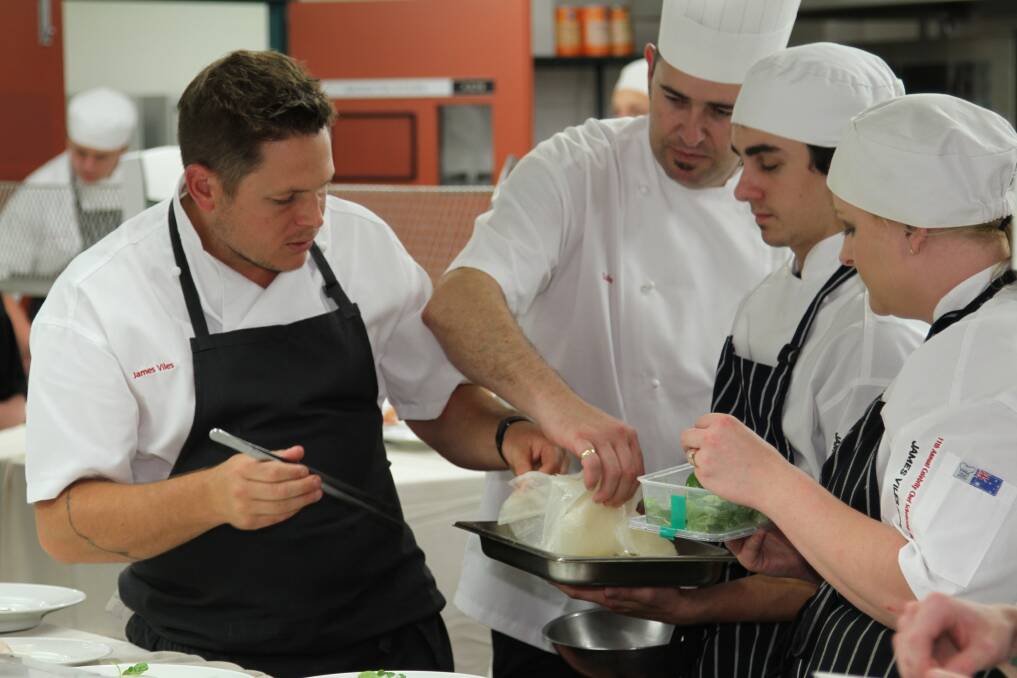 Celebrity chef James Viles works with apprentices preparing for the Celebrity Chef Dinner at TAFE Illawarra's Nowra campus. Picture: GREG ELLIS
