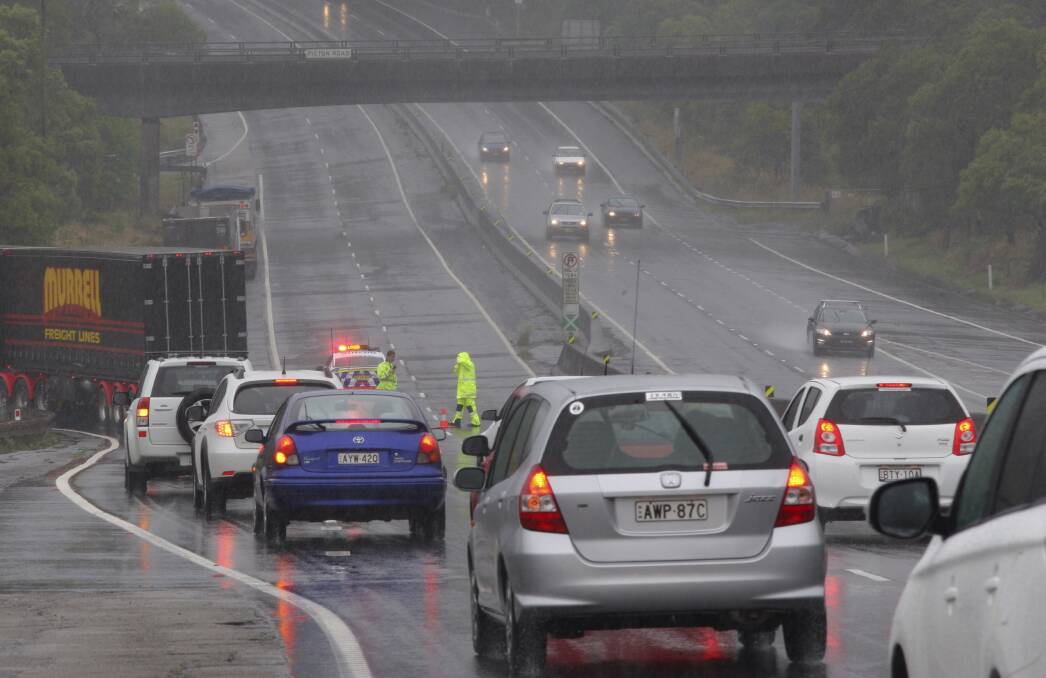 A fallen tree on the M1 Princes Motorway caused delays yesterday. Picture: ADAM McLEAN