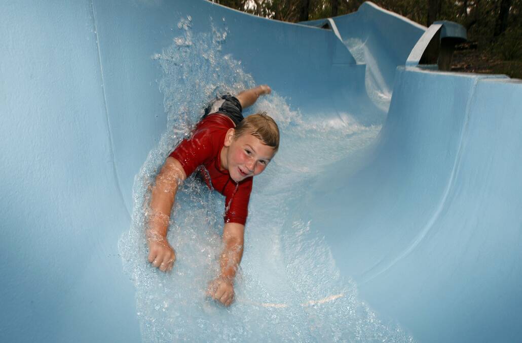 Cubs from 1st Berowra enjoy the waterslide. Picture: ANDY ZAKELI